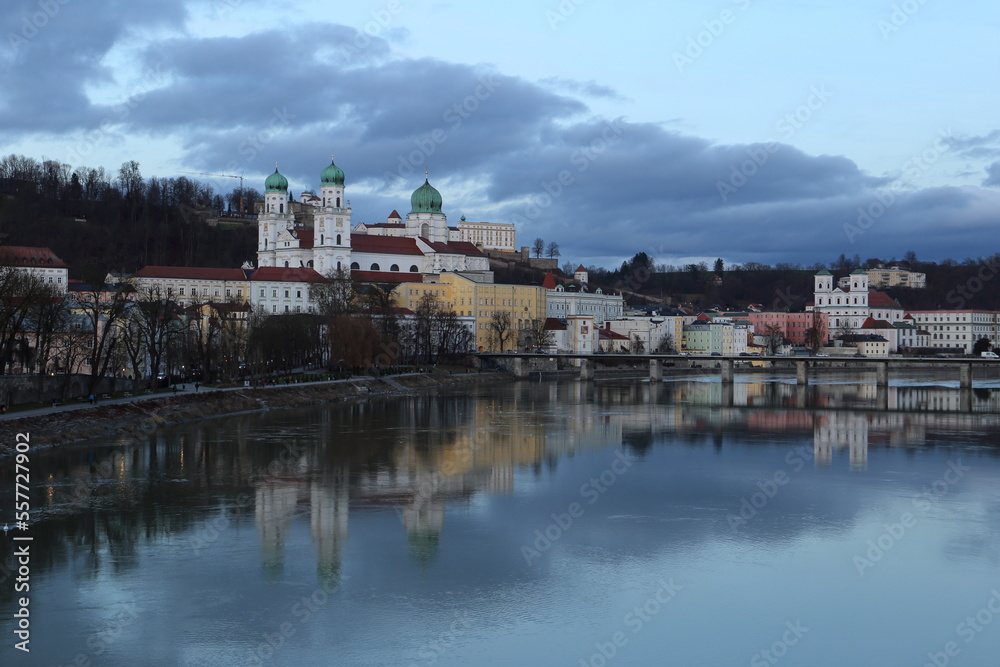 Passau old town evening landscape.  Beautiful St. Stephen's cathedral and inn promenade mirroring in water.