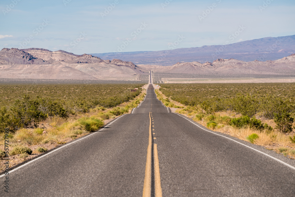 Symmetrical straight road with no cars in Death Valley in USA