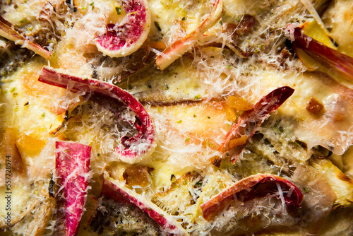 Neapolitan pizza with guanciale, pecorino and radicchio. Classic Italian recipe. Guanciale is an Italian non-smoked cured meat prepared with pork cheeks or cheeks.