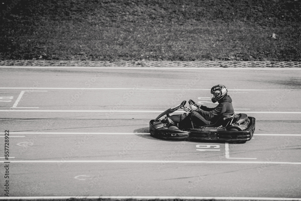 Black and white photo amateur of go cart racer finishing practice run