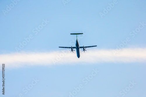 Propeller airplane lifting off from below