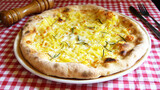 Four Cheese Pizza. Neapolitan pizza made with a variety of European cheeses such as Mozzarella, Brie and Gorgonzola. Italian vegetarian recipe.