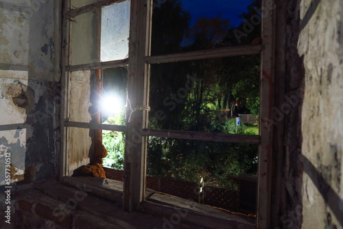 view outside from an antique old window within ruins in dark night with street light shining in kremnica in slovakia photo