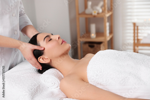 Beautiful woman receiving massage in beauty salon, closeup