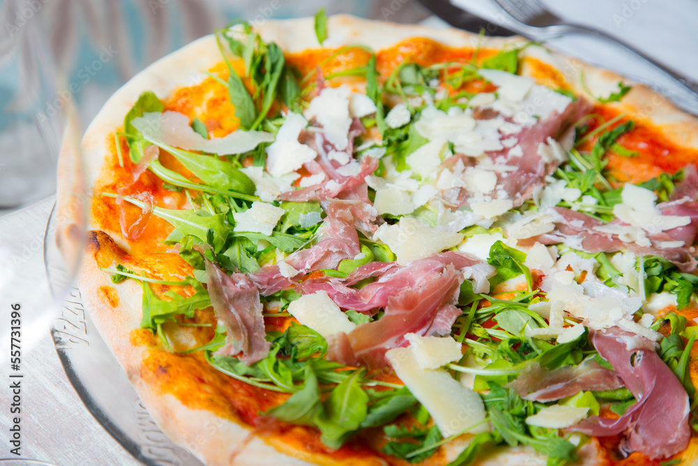 Serrano ham pizza. Neapolitan pizza made with baked vegetables and serrano ham. Italian recipe. Serrano ham pizza. Neapolitan pizza made with baked vegetables and serrano ham. Italian recipe.