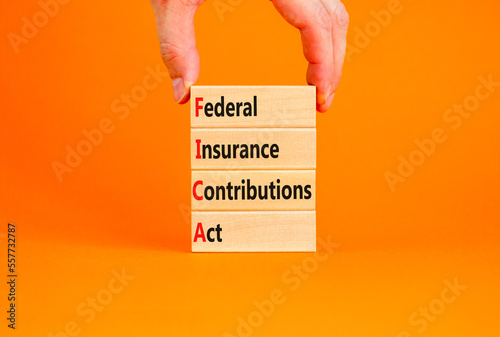 FICA symbol. Concept words FICA federal insurance contributions act on wooden block on beautiful orange background. Business FICA federal insurance contributions act concept. Copy space. photo