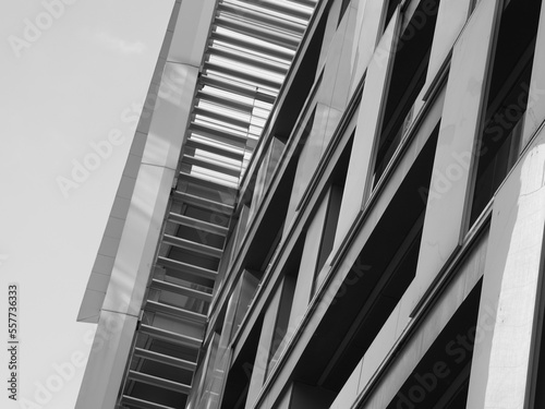 urban building side grayscale and moon in the sky
