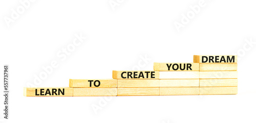 Create your dream symbol. Concept words Learn to create your dream on wooden blocks. Beautiful white table white background. Business learn to create your dream concept. Copy space.