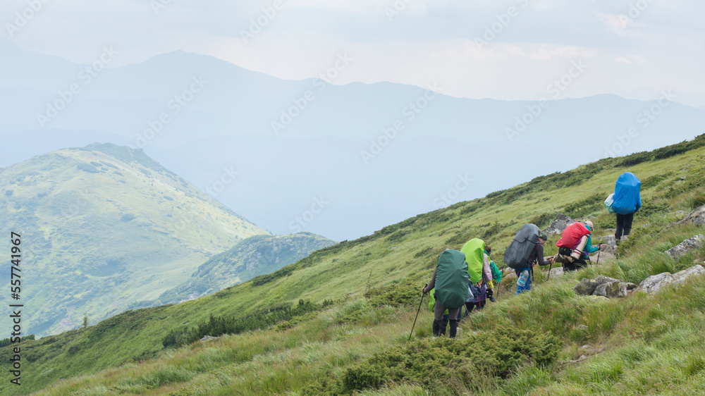 Tourists walk along a mountain path.