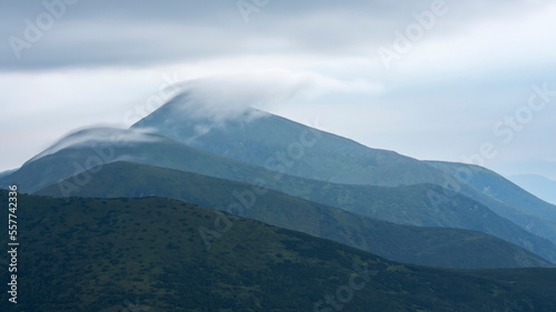 Foggy landscape of mountains. The peaks of the Chornohora mountain range (Ukrainian Carpathians).