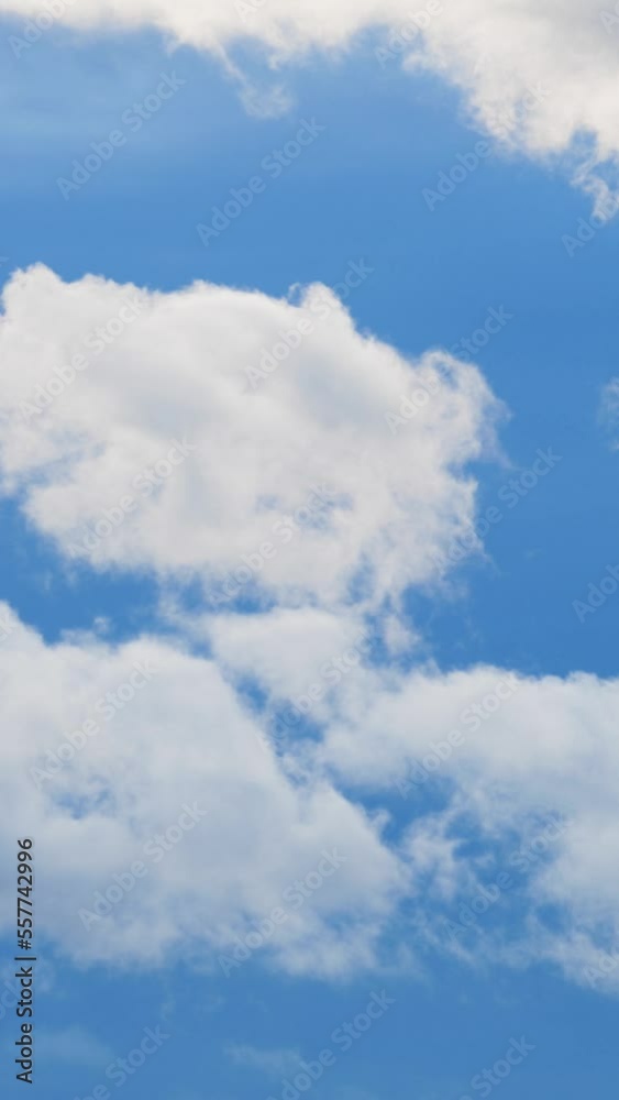 Vertical Screen: Blue Sky with White Cumulus Fluffy Clouds. Clear Heaven and Good Weather with Wind in Time Lapse. Beautiful Summer Landscape In Clean Atmosphere. Shot for Social Media Vertical Screen: Blue Sky with White Cumulus Fluffy Clouds. Clear Heaven and Good Weather with Wind in Time Lapse. Beautiful Summer Landscape In Clean Atmosphere. Shot for Social Media
