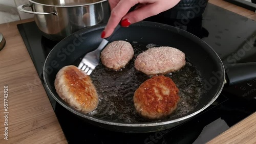 The process of cooking and roasting beef meat cutlets in a frying pan. Food preparation, homemade cuisine, traditional Polish dish photo