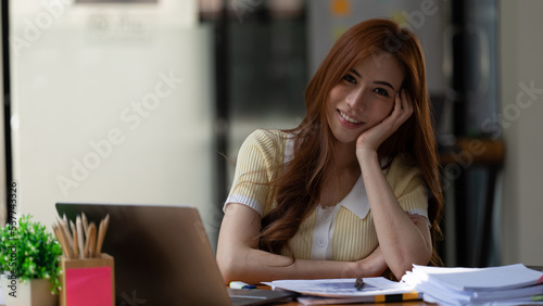 Closeup of relaxed young beautiful young business woman smiling photo