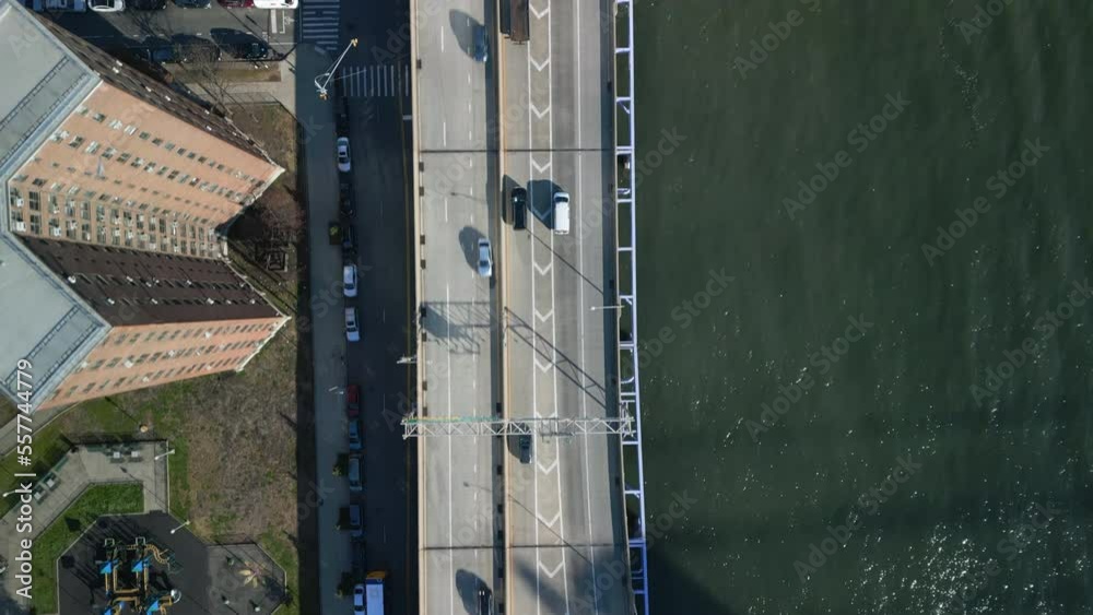 Birds eye shot of traffic on multilane waterfront drive. Apartment buildings and sports area aside road. New York City, USA Birds eye shot of traffic on multilane waterfront drive. Apartment buildings and sports area aside road. New York City, USA