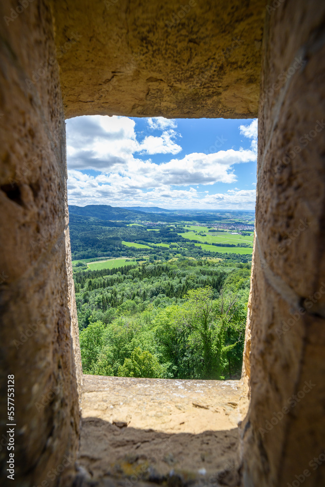 framed view through old stone castle window onto german countryside