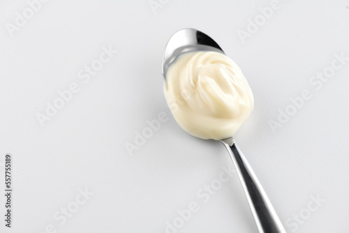 Mayonnaise. Spoon of homemade healthy mayonnaise sauce, soft cream. Healthy food ingredients. on white background. Salad dressing. 