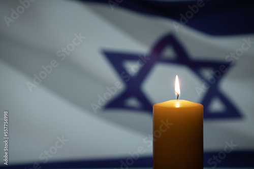 Fotografie Burning candle on Israel flag background