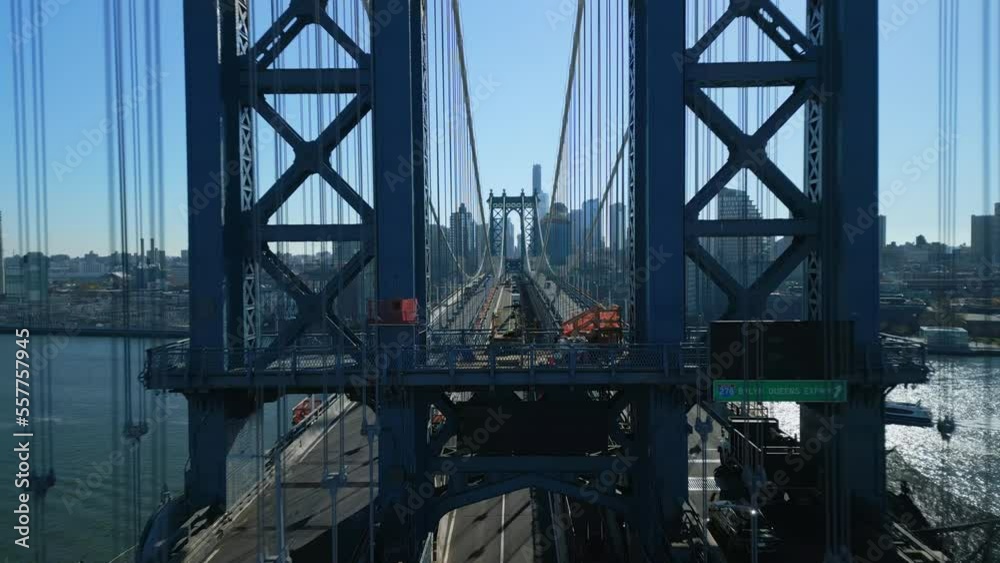 Forwards fly between supporting ropes of Manhattan Bridge. Amazing transport structure over East River. New York City, USA Forwards fly between supporting ropes of Manhattan Bridge. Amazing transport structure over East River. New York City, USA