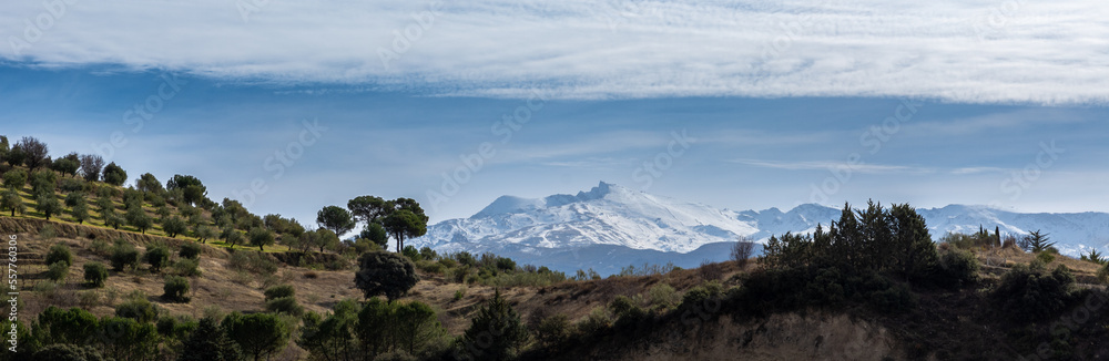 Panoramic view of the snow-capped Veleta, the second highest peak of the Sierra Nevada (Spain)