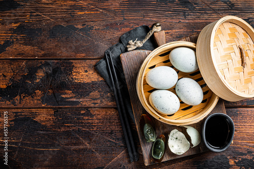 Black Century eggs, preserved duck egg, Chinese cuisine. Wooden background. Top view. Copy space