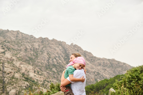 Mother and child embracing in nature. Cancer concept