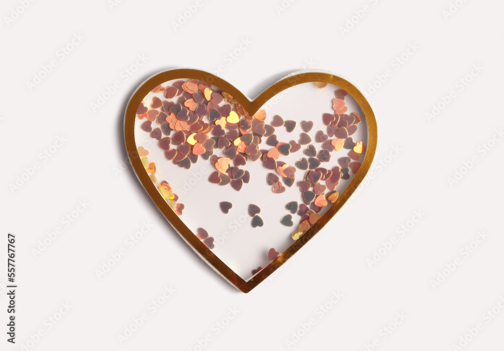 Gold (bronze) glitter heart on beige empty paper background. Abstract copy space texture. Gold (bronze) glitter heart on beige empty paper background. Abstract copy space texture.