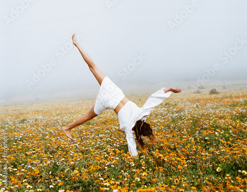 woman in the field doing cartwheel photo