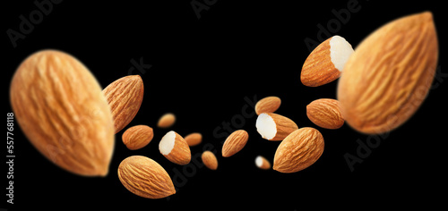 Flying delicious almonds, isolated on black background
