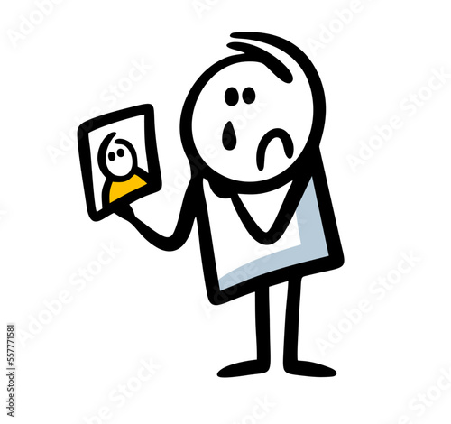 Sad man holds photo of his beloved and looks with tears.