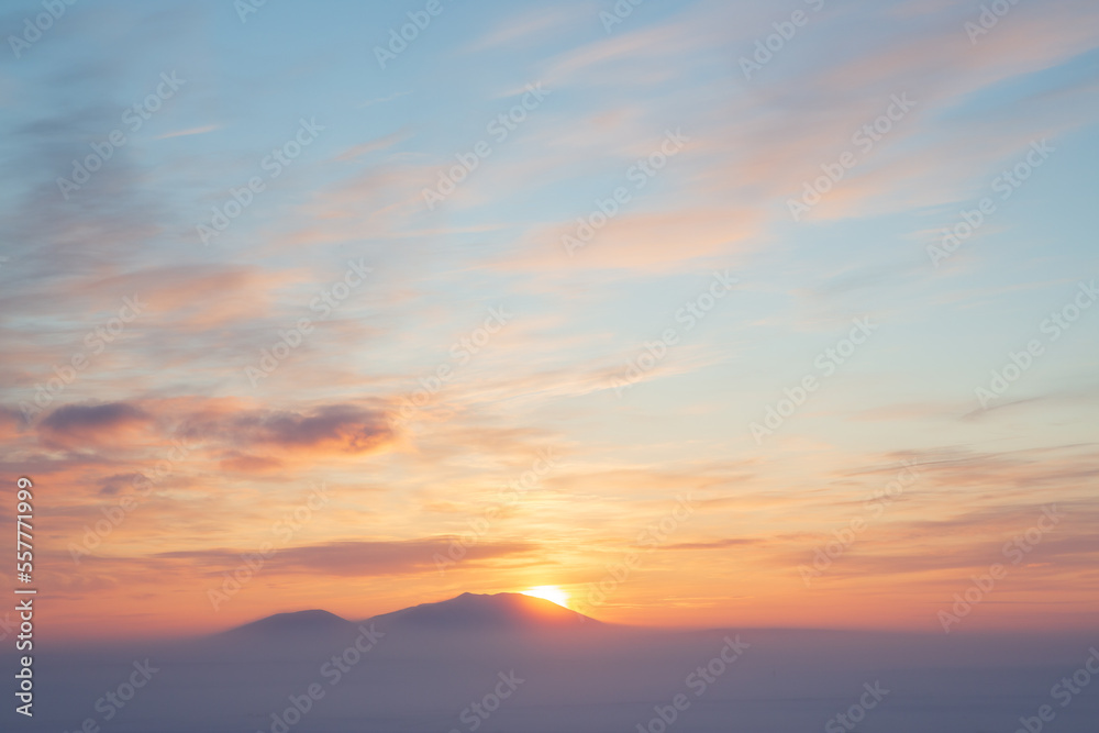 Winter arctic landscape. Sunset over the tundra and snow-capped mountains. Frosty fog over the winter tundra. Cold winter weather. The nature of Chukotka and polar Siberia. Far North of Russia, Arctic
