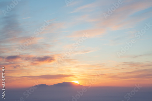 Winter arctic landscape. Sunset over the tundra and snow-capped mountains. Frosty fog over the winter tundra. Cold winter weather. The nature of Chukotka and polar Siberia. Far North of Russia, Arctic