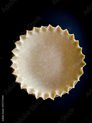 Empty Crimped Pie Dough Crust on Black Background