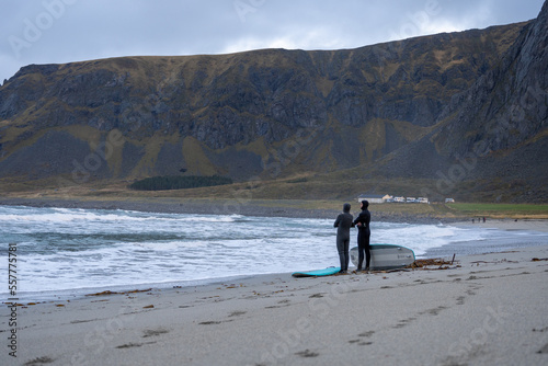 Surfers at Unstad Beach in Lofoten Islands, Norway