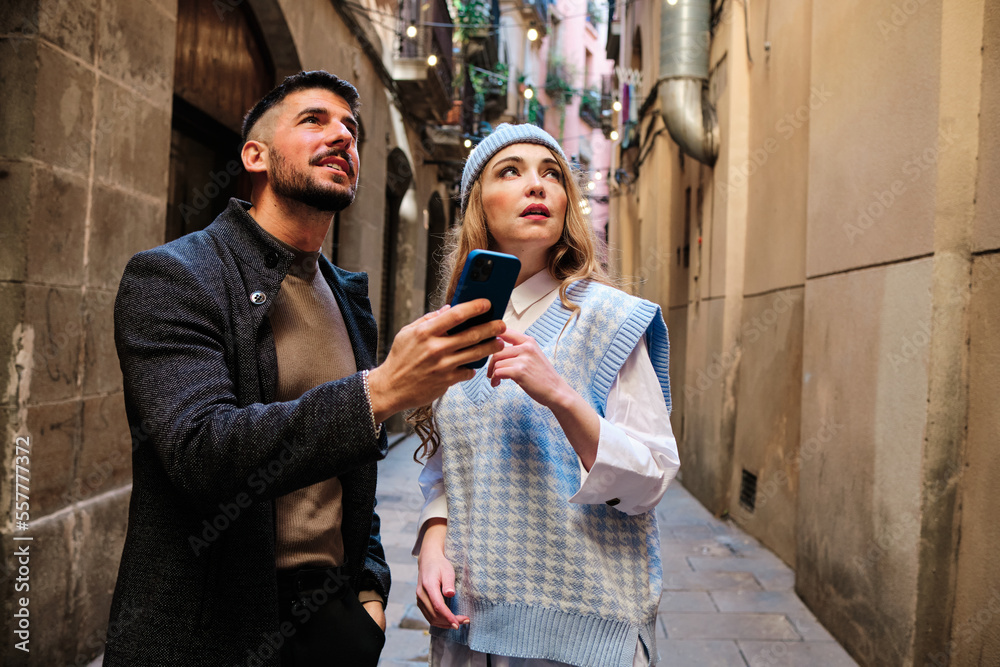 Lost tourist couple locating themselves with the mobile