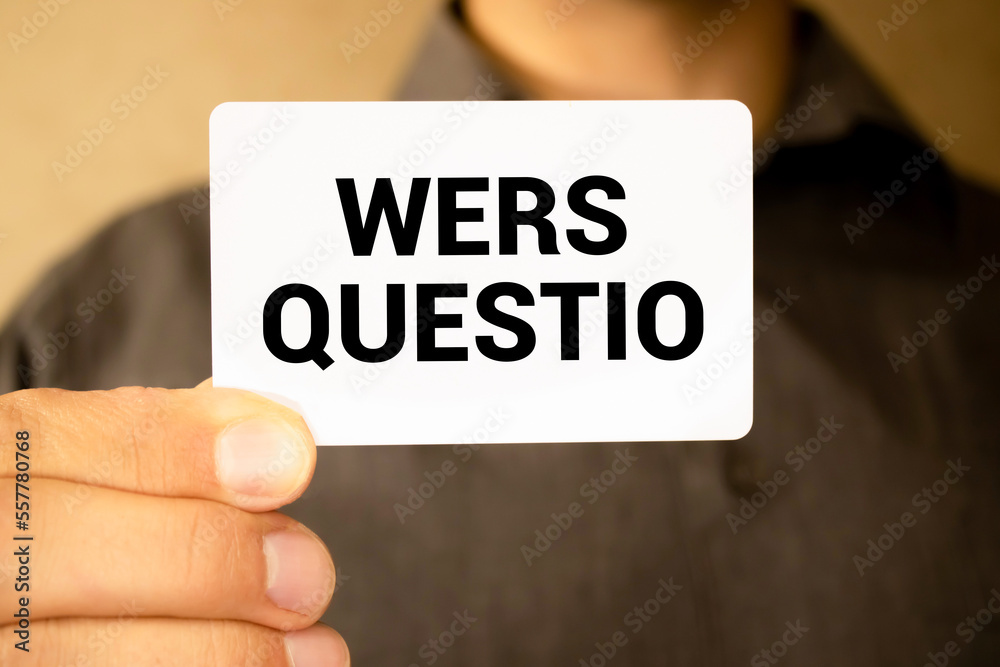 On a wooden table are two wooden blocks with the text question WE ARE HIRING On a wooden table are two wooden blocks with the text question WE ARE HIRING
