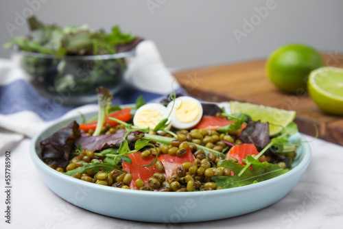 Plate of salad with mung beans on white marble table