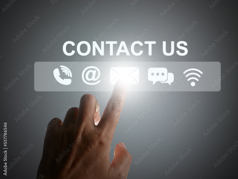 Contact us or Customer support concept. Finger tapping on a virtual screen of contact icons: phone, address, email, live chat, and internet wifi Contact us or Customer support concept. Finger tapping on a virtual screen of contact icons: phone, address, email, live chat, and internet wifi