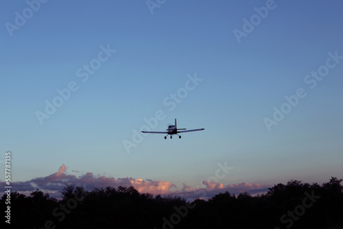 Modern ultralight airplane flying in blue sky photo