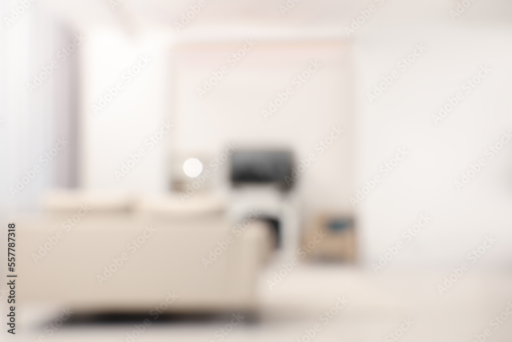 Naklejka premium Blurred view of stylish living room interior with cozy sofa