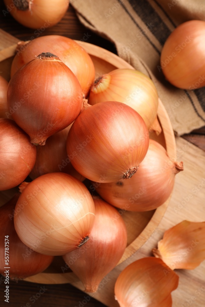 Many ripe onions on wooden table, flat lay Many ripe onions on wooden table, flat lay