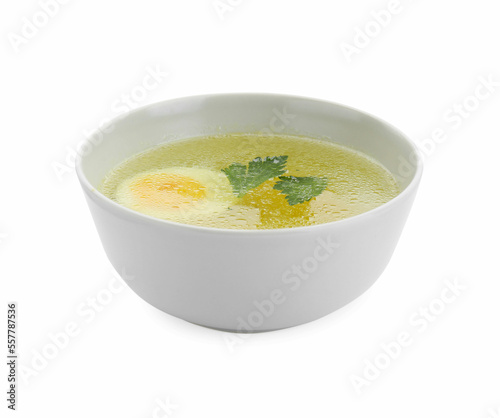 Delicious chicken bouillon with egg and parsley in bowl on white background