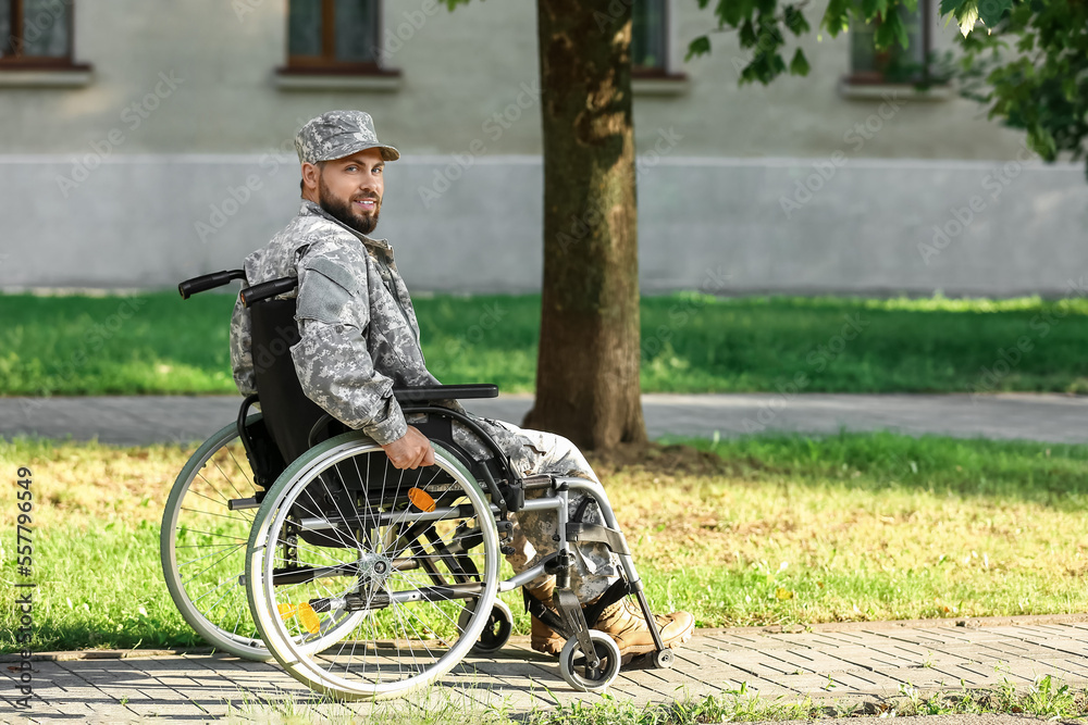 Young soldier in wheelchair outdoors Young soldier in wheelchair outdoors