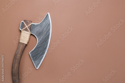 Ax on brown background, top view