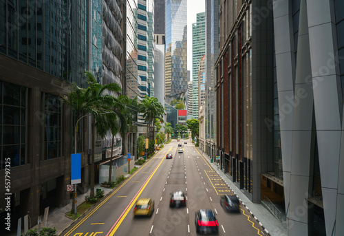 Street and car on traffic moving in downtown business financial district with skyscraper building in morning at Singapore.