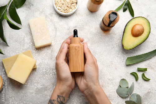 Female hands with bottle of...