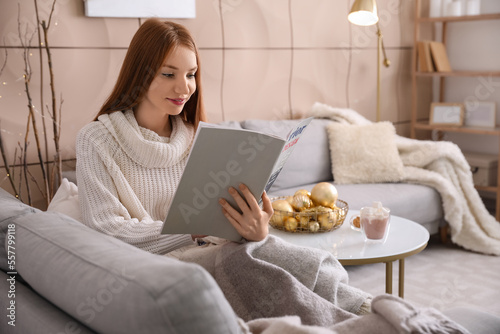 Young redhead woman reading...