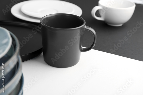 Mug on black and white table, closeup