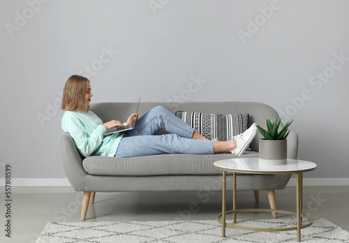Young woman using laptop on...