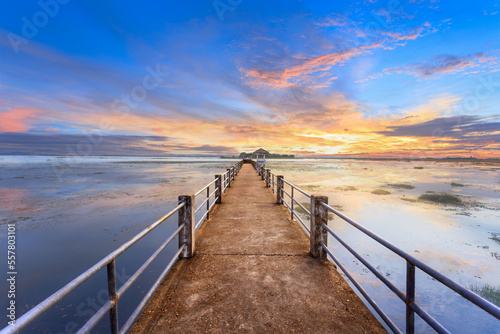 Fototapeta Naklejka Na Ścianę i Meble -  Empty concrete bridge under sunset golden sky with clouds above lake, tourist attraction Nong Han lake at Sakon Nakhon province in thailand