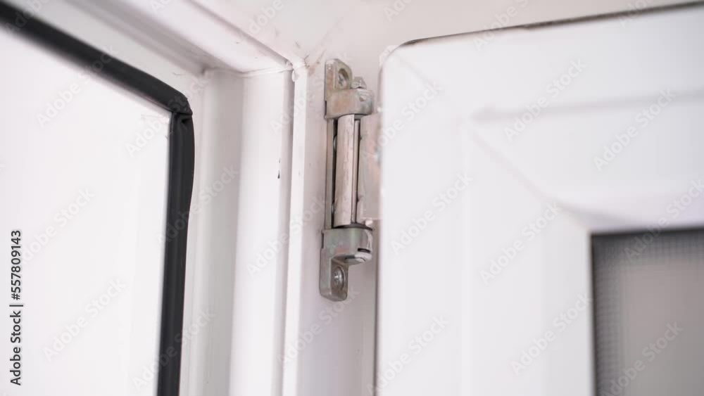 Smooth parallax around the upper door hinge of a white plastic door close-up Smooth parallax around the upper door hinge of a white plastic door close-up